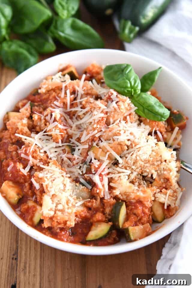 One-Pan Italian Cheesy Chicken and Zucchini 2 Serving of Italian chicken zucchini skillet meal in white bowl.