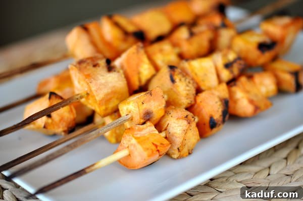 Fire-Kissed Sweet Potato Skewers 3 Rectangular white platter presenting perfectly grilled sweet potato skewers.