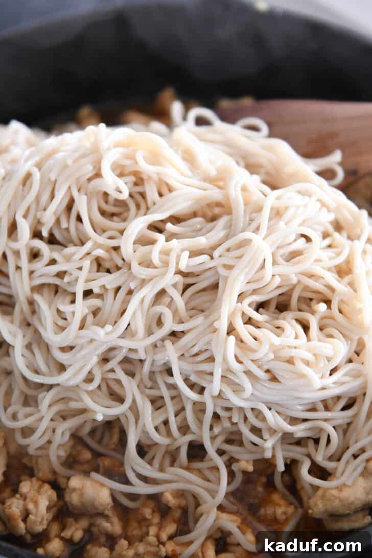 Effortless Fiery Garlic Ramen 6 Ramen noodles in skillet with ground turkey.
