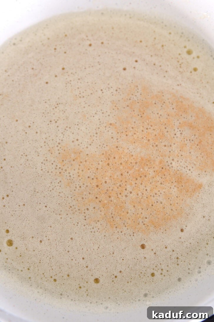 Perfectly browned butter in a white skillet, showcasing the rich amber color of the toasted milk solids.