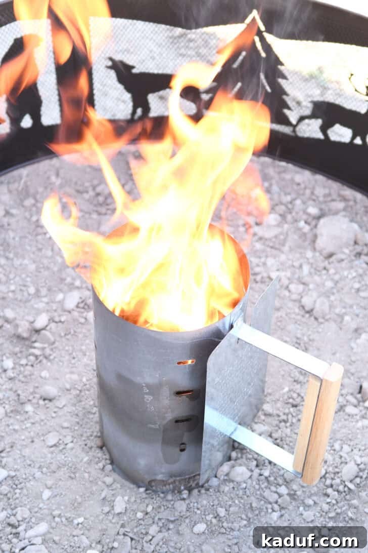 Hearty Dutch Oven Lasagna 11 Fire coming out of the top of a chimney starter with briquettes, ready for cooking.