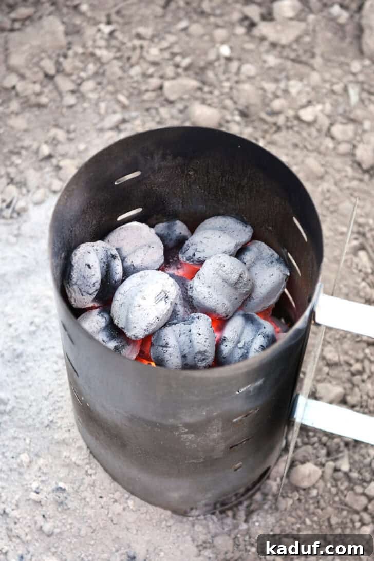Hearty Dutch Oven Lasagna 12 Chimney starter filled with hot coals/briquettes, ash-covered and ready for use.