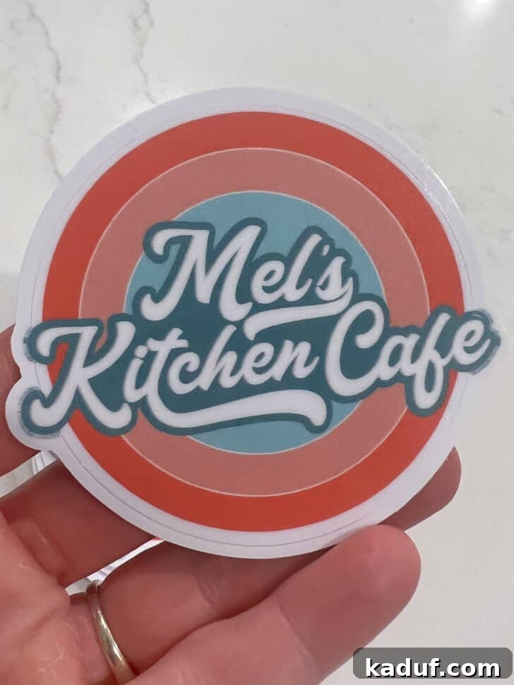 Friday Thoughts: A Brain Dump 11 A branded Mel's Kitchen Cafe sticker with a whimsical design, a memento from the cookbook launch.