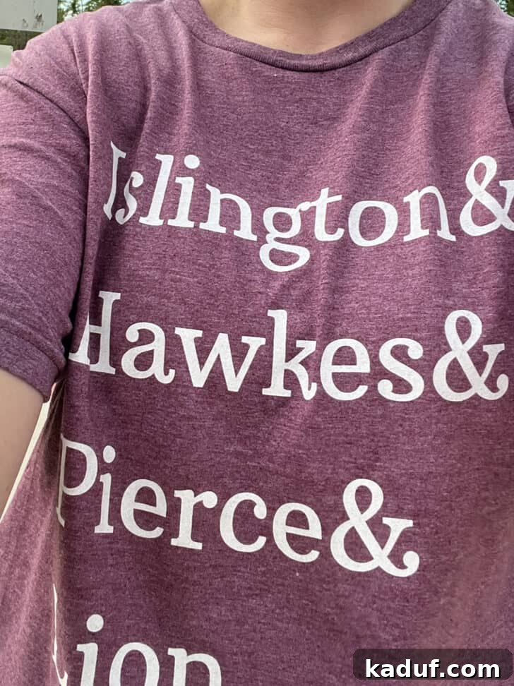 Friday Thoughts: A Brain Dump 12 A person wearing a witty 'Emma M. Lion' t-shirt, showcasing a beloved literary reference.