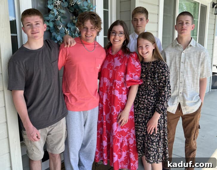 Friday Thoughts: A Brain Dump 13 A warm family portrait featuring a mom happily surrounded by her five children outdoors, reflecting their close bond.