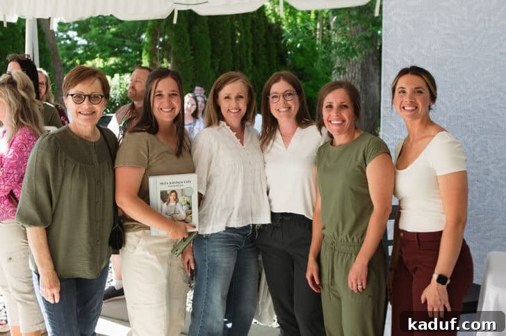 Friday Thoughts: A Brain Dump 9 Mel's Kitchen Cafe author smiling warmly with guests at her successful cookbook signing event.