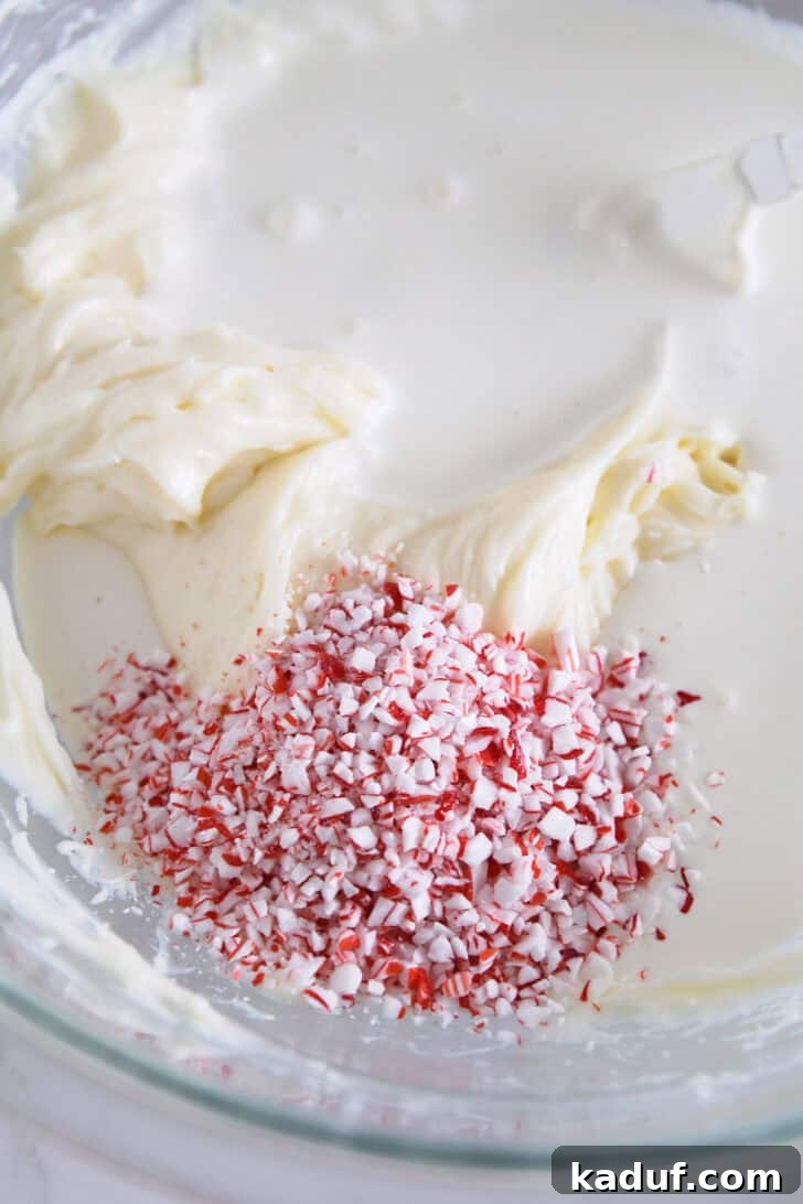 Mint Chocolate Brownie Trifle 5 Close-up of crushed peppermint pieces in a bowl with heavy cream and softened cream cheese.