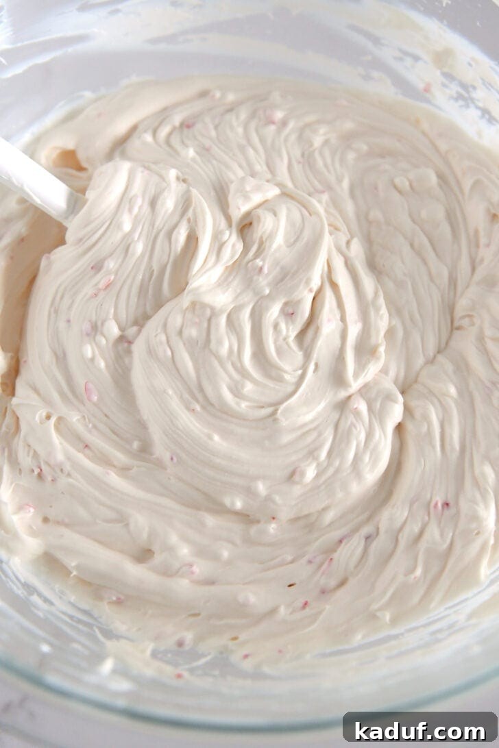 Mint Chocolate Brownie Trifle 6 Glass bowl with a thick, creamy peppermint cream cheese mixture, ready for layering.