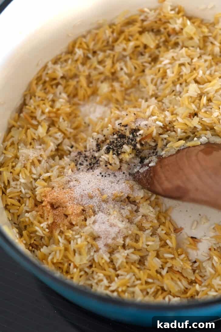 Ultimate Rice Pilaf 4 Garlic powder, onion powder, salt, and pepper being added to rice, orzo, and butter in a pot.