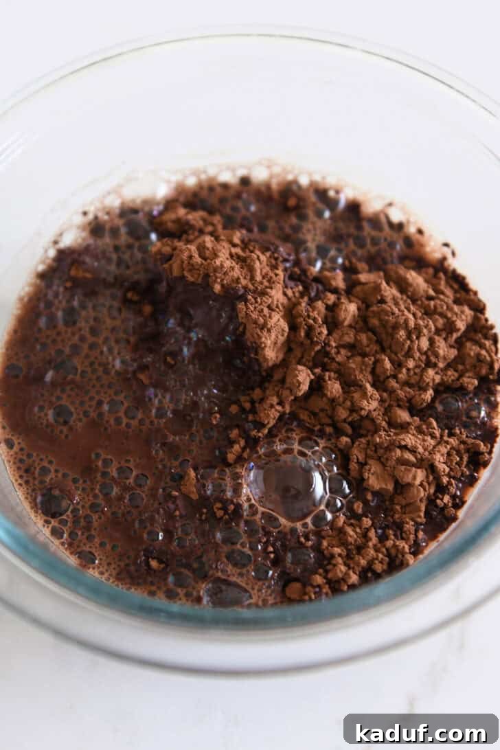Velvety Chocolate Olive Oil Cake 4 Glass bowl with boiling water and cocoa powder.