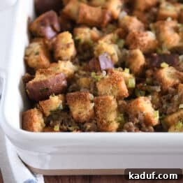 White 9X13-inch pan with baked sausage and herb stuffing, ready to be served.