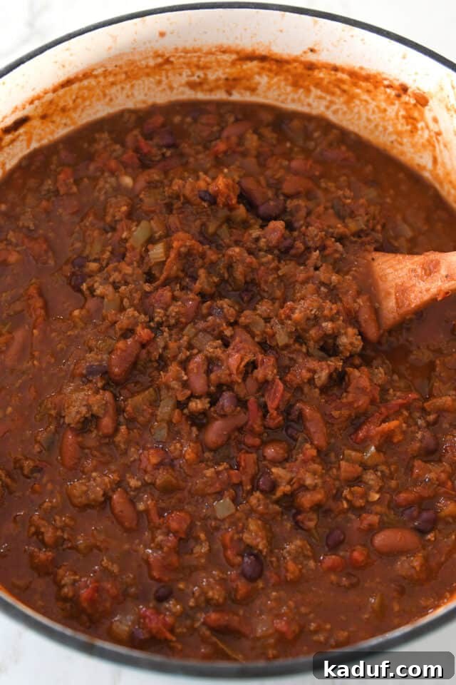 Sugarcane Spice Chili 6 Cooked red chili with beans and ground beef in cast iron pot.