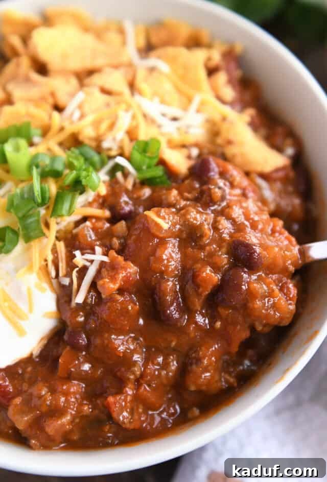 Sugarcane Spice Chili 8 Red chili with ground beef and beans in gray bowl.