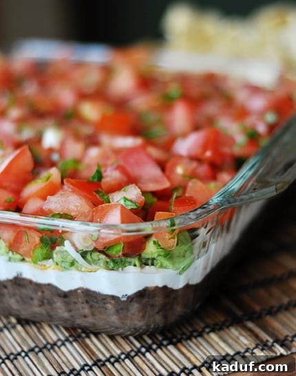 Irresistible 7-Layer Dip 2 Glass 9x13 full of 7 layer dip.