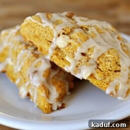 A delicious pumpkin scone with ginger glaze, ready to be enjoyed.