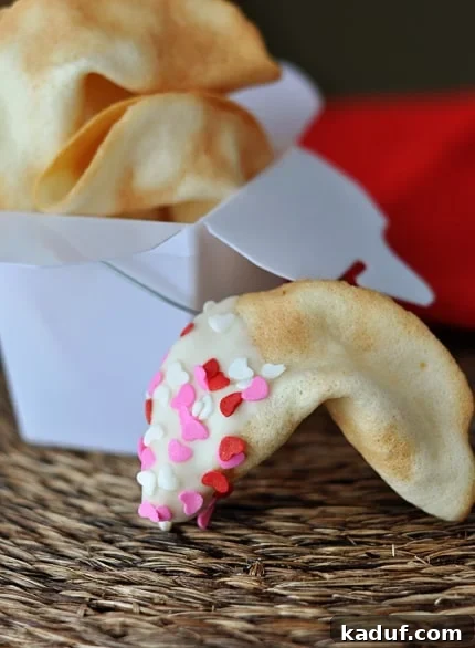 Baking Your Own Fortunes 2 White container full of fortune cookies, with a half-dipped and sprinkled fortune cookie laying in front of the container.