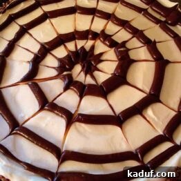 No-Bake Spiderweb Cheesecake, a festive and easy Halloween dessert.