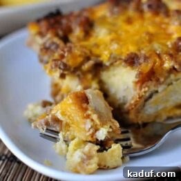 Beautifully golden Make-Ahead Sausage and Egg Breakfast Bake on a white plate.