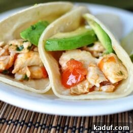 Close-up of a skillet full of cilantro lime fish taco filling, showcasing the vibrant colors and tender fish.