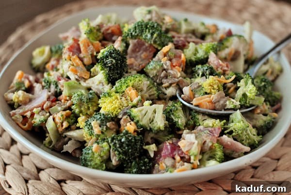 Creamy Broccoli Delight 2 A large, inviting bowl filled with vibrant homemade broccoli salad, garnished with crisp bacon and sunflower seeds, ready for serving.
