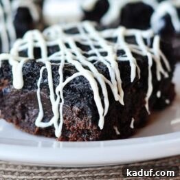 A perfectly portioned square of Oreo Truffle Brownie on a plate.