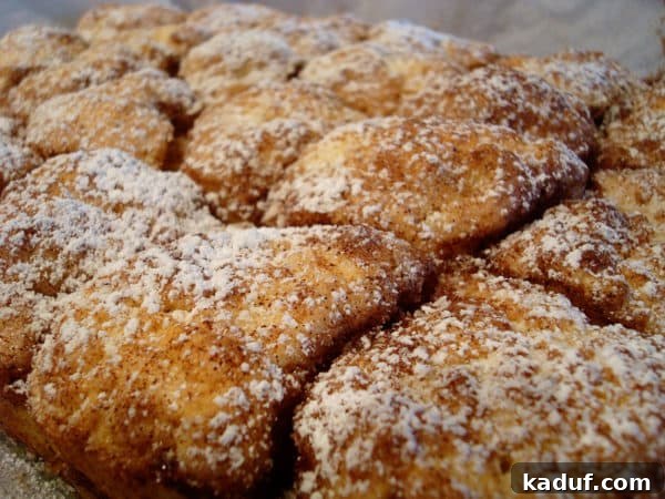 Celebration Morning Buns 3 A pan filled with golden-brown, sugar-dusted sweet buns, fresh from the oven.