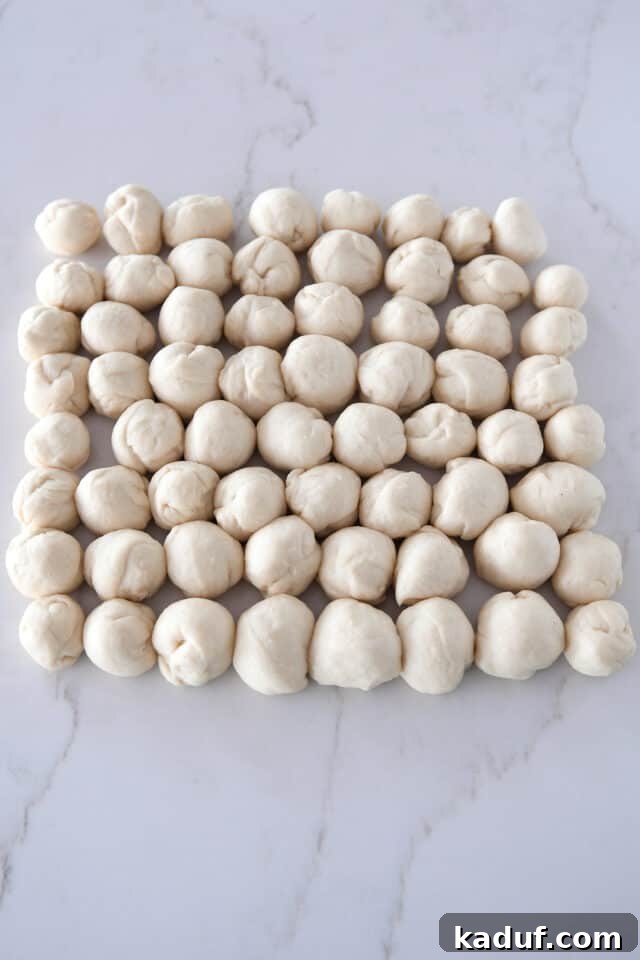 The Ultimate Sticky Pull Apart Monkey Bread 6 All 64 pieces of dough, individually rolled into small, rustic balls, awaiting their delicious coating.
