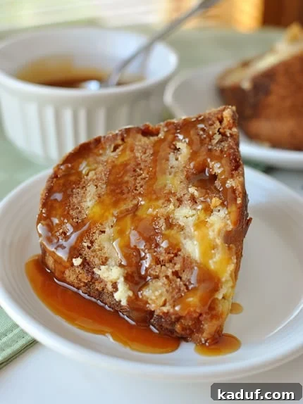 Heavenly Caramel Apple Bundt 2 A piece of caramel drizzled apple bundt cake on a white plate.