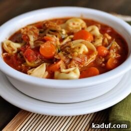 Tortellini Sausage Soup in a white bowl
