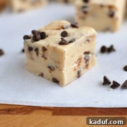 Top-down view of a slab of Chocolate Chip Cookie Dough Fudge, garnished with mini chocolate chips, set to be sliced.