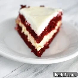 Red Velvet Cheesecake Dream 5 A square image of a slice of Red Velvet Cheesecake Cake.