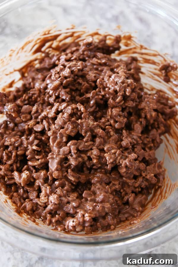 Ultimate Crunch Brownies 8 A glass bowl filled with the completed peanut butter, chocolate, and rice krispie mixture, ready to be spread.