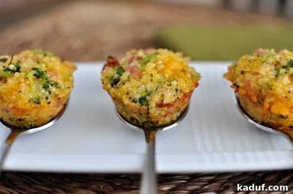 Cheesy Ham Broccoli Quinoa Poppers 2 Three cooked mini cheese and broccoli quinoa bites on spoons.