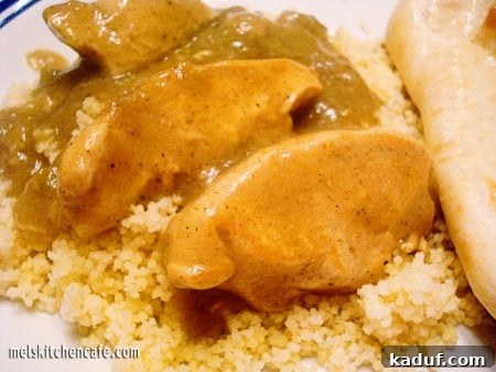 Vibrant Green Curry Chicken 2 Delicious slices of chicken with vibrant green curry sauce served over fluffy couscous.