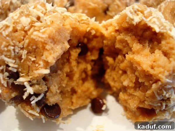 Crunchy Peanut Butter Bliss Bites 3 A peanut butter chocolate chip snack ball split in half, revealing its crunchy interior and delicious ingredients.