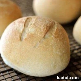 A freshly baked, golden-brown artisan bread bowl, ready to be filled.