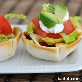 Tiny Taco Treats 5 A selection of Mini Taco Cups with various fresh toppings, showcasing their appealing bite-sized form.