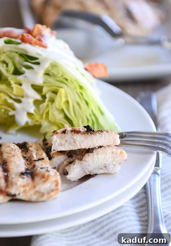 Grilled lemon garlic chicken cut into savory pieces on a white plate, ready for serving.