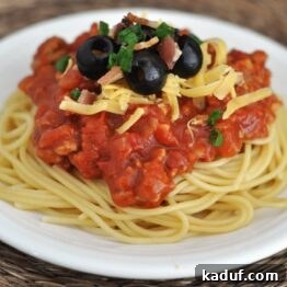 A delightful close-up of Cowboy Spaghetti, perfectly garnished and ready to serve.
