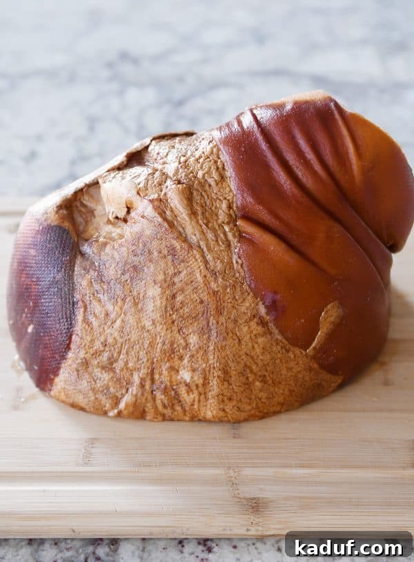 Sweet Glazed Baked Ham 6 Bone-in ham on cutting board.