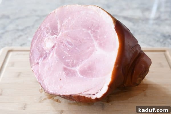Sweet Glazed Baked Ham 7 Bone-in ham on cutting board.
