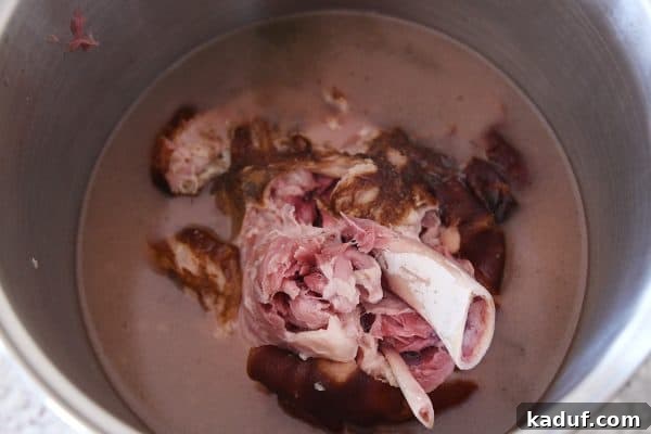 Sweet Glazed Baked Ham 8 Cooked ham falling apart tender in large pot.