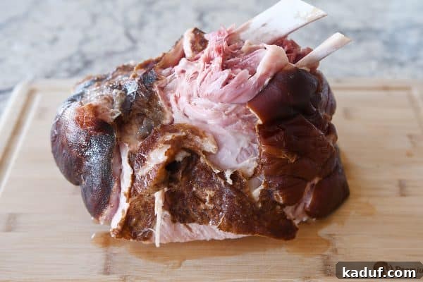 Sweet Glazed Baked Ham 9 Cooked ham falling apart tender on cutting board.