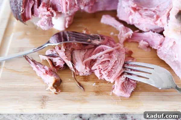 Sweet Glazed Baked Ham 10 Shredding sweet baked ham with two forks.