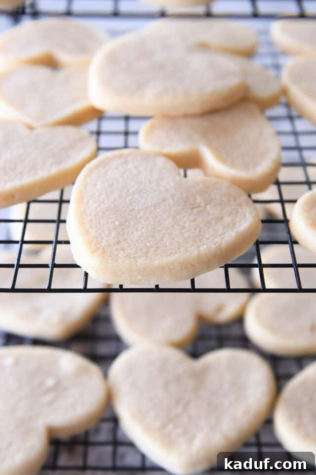 Velvet Cloud Sugar Cookies 7 Heart shaped sugar cookies on baking cooling rack.