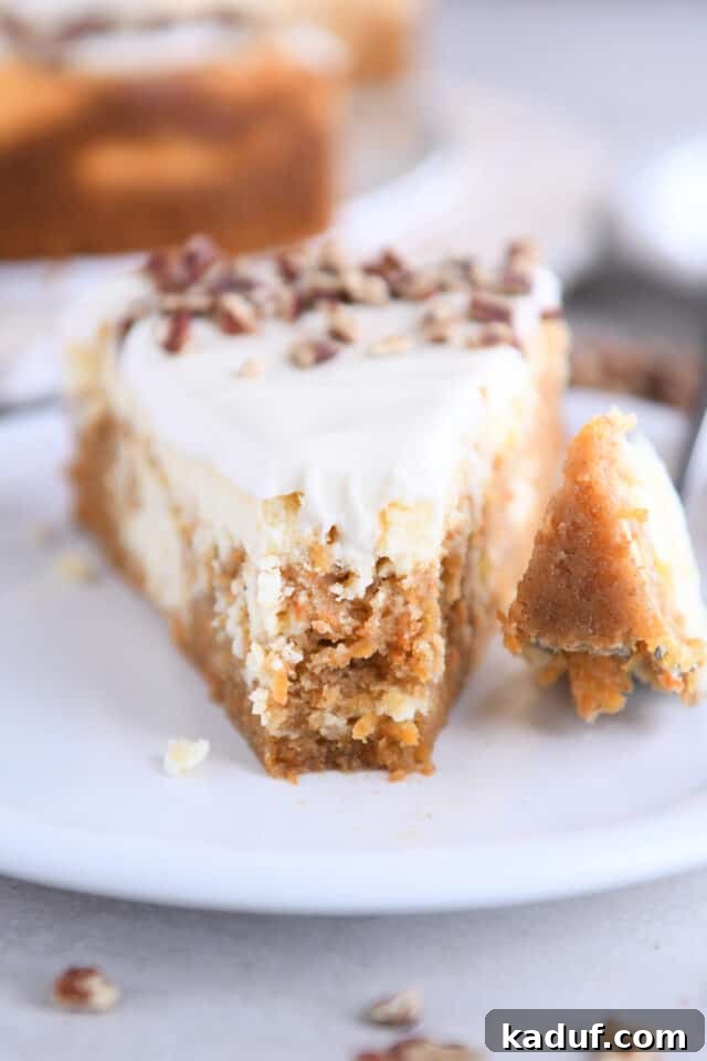 Carrot Cake Cheesecake Fusion 10 A close-up of a slice of carrot cake cheesecake on a white plate, with a bite playfully taken out, highlighting the rich layers.