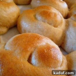 A dish of golden brown baked garlic knots, ready for serving.