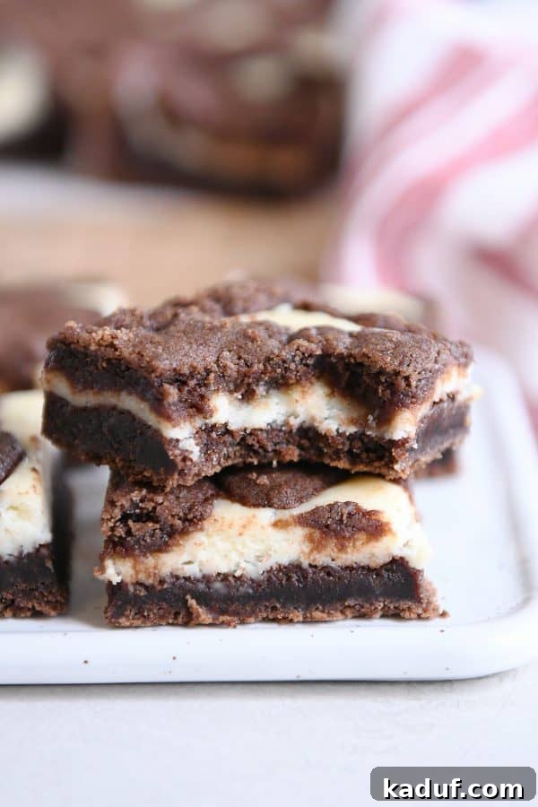Zebra Cheesecake Brownies 10 Another view of stacked black and white cheesecake brownies, emphasizing their appealing contrast and texture.