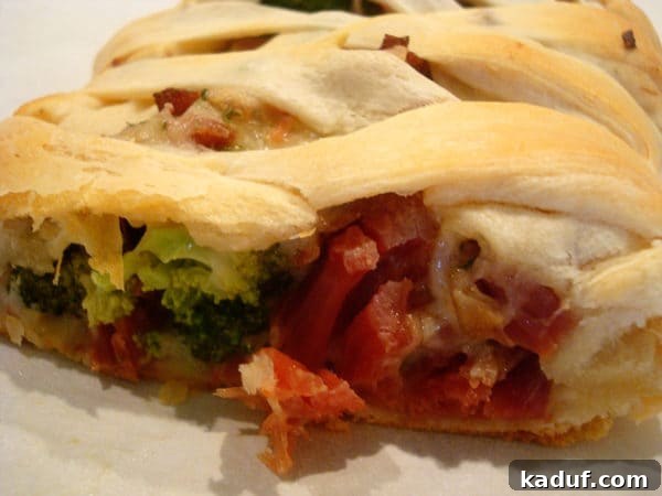 Golden Cheesy Ham and Broccoli Crescent Braid 3 Bread filled with cheese ham and broccoli. A close-up of the golden-brown Cheesy Ham and Broccoli Crescent Braid, revealing its delicious filling with melted cheese and tender broccoli.