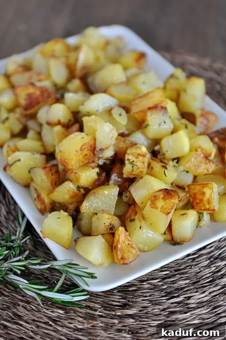 Sizzling Skillet Spuds 2 A white dish with golden brown cooked potato cubes, perfectly seasoned and ready to serve.
